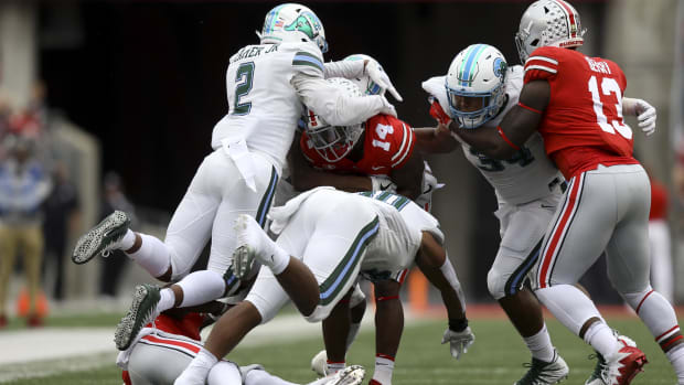 Ohio State receiver K.J. Hill (14) is tackled by Tulane linebacker Zachery Harris and safety Roderic Teamer Jr 