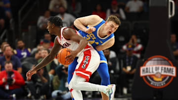 Dec 14, 2024; Phoenix, Arizona, USA; UCLA Bruins forward Tyler Bilodeau (34) reacts as Arizona Wildcats guard Jaden Bradley (0) collides with him in the second half at Footprint Center. Mandatory Credit: Mark J. Rebilas-Imagn Images
