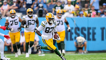 Sep 22, 2024; Nashville, Tennessee, USA;  Green Bay Packers wide receiver Romeo Doubs (87) makes a catch and runs the ball against the Tennessee Titans during the first half at Nissan Stadium. Mandatory Credit: Steve Roberts-Imagn Images