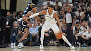 Spurs forward Victor Wembanyama dribbles against Nets forward Noah Clowney.