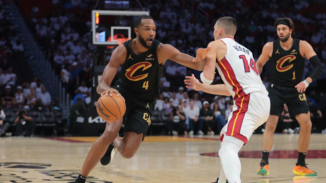 Apr 26, 2025; Miami, Florida, USA; Cleveland Cavaliers forward Evan Mobley (4) drives to the basket against Miami Heat guard Tyler Herro (14) in the first quarter during game three for the first round of the 2025 NBA Playoffs at Kaseya Center. Mandatory Credit: Sam Navarro-Imagn Images
