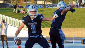 Petoskey's Seth Marek (left) celebrates a touchdown in last Friday's win with teammate Mitch Eberhart against Escanaba.