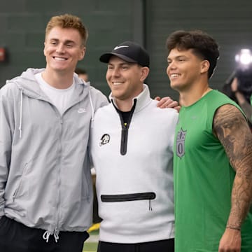 Denver Broncos quarterback Bo Nix, a former Oregon quarterback, left, and Oregon quarterback Dillon Gabriel, right, take a picture with Oregon offensive coordinator and quarterbacks coach Will Stein during the Oregon football’s Pro Day Tuesday, March 18, 2025, at the Moshofsky Center in Eugene, Ore.