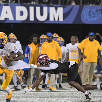 Miami Northwestern's Calvin Russell Jr. breaks a tackle during the Class 3A state championship against Jacksonville Raines on Dec. 14, 2024. Northwestern won 41-0. The schools play again in a rematch for the 3A title on Friday, Dec. 12, 2025.