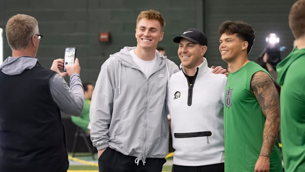 Denver Broncos quarterback Bo Nix, a former Oregon quarterback, left, and Oregon quarterback Dillon Gabriel, right, take a pi