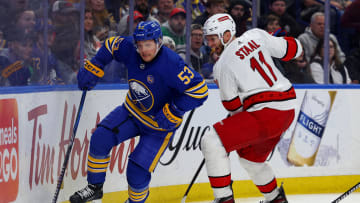Feb 25, 2024; Buffalo, New York, USA;  Carolina Hurricanes center Jordan Staal (11) defends as Buffalo Sabres left wing Jeff Skinner (53) controls the puck behind the net during the second period at KeyBank Center. Mandatory Credit: Timothy T. Ludwig-USA TODAY Sports