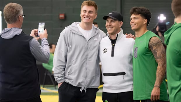 Denver Broncos quarterback Bo Nix, a former Oregon quarterback, left, and Oregon quarterback Dillon Gabriel, right, take a pi