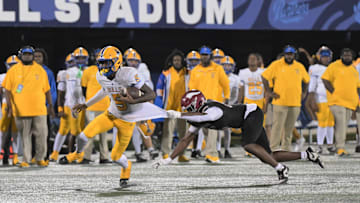 Miami Northwestern's Calvin Russell Jr. breaks a tackle during the Class 3A state championship on Dec. 14, 2024.
