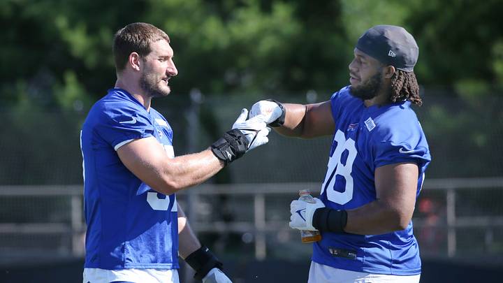 Bills edge Joey Bosa fist-bumps rookie tackle T.J. Sanders between drills during the opening day of Buffalo Bills training camp at St. John Fisher University Wednesday, July 23, 2025 in Pittsford.