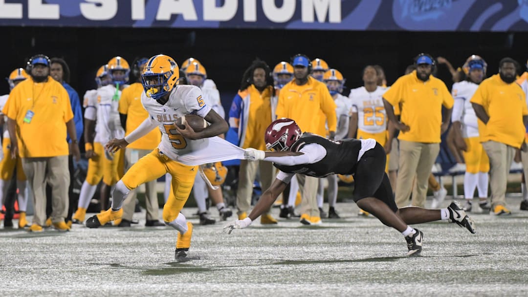 Miami Northwestern's Calvin Russell Jr. breaks a tackle during the Class 3A state championship on Dec. 14, 2024.