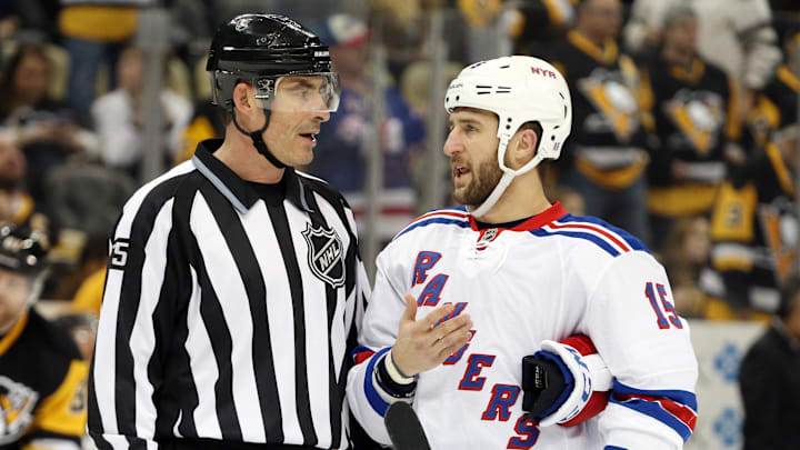 Mar 3, 2016; Pittsburgh, PA, USA; NHL linesman Derek Amell (75) talks with New York Rangers left wing Tanner Glass (15) during a time-out against the Pittsburgh Penguins in the second period at the CONSOL Energy Center. The Penguins won 4-1. Mandatory Credit: Charles LeClaire-Imagn Images