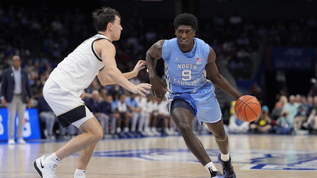 Mar 13, 2025; Charlotte, NC, USA; North Carolina Tar Heels guard Drake Powell (9) goes to the basket against Wake Forest Demon Deacons guard Parker Friedrichsen (7) during the first half at Spectrum Center. Mandatory Credit: Jim Dedmon-Imagn Images