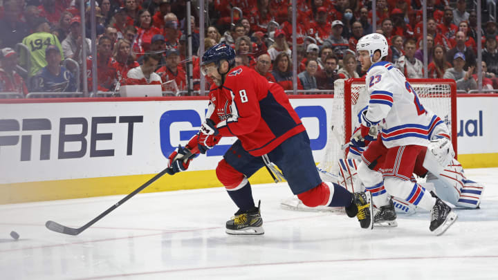 Apr 28, 2024; Washington, District of Columbia, USA; Washington Capitals left wing Alex Ovechkin (8) reaches for the puck as New York Rangers defenseman Adam Fox (23) defends in the first period in game four of the first round of the 2024 Stanley Cup Playoffs at Capital One Arena. Mandatory Credit: Geoff Burke-USA TODAY Sports