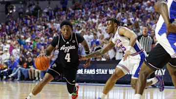 Mar 1, 2025; Gainesville, Florida, USA; Texas A&M Aggies guard Wade Taylor IV (4) dribbles the ball around Florida Gators guard Alijah Martin (15) during the first half at Exactech Arena at the Stephen C. O'Connell Center. Mandatory Credit: Morgan Tencza-Imagn Images