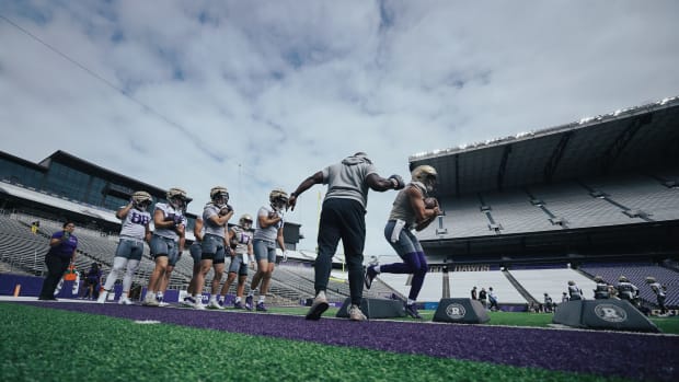 Keleki Latu, third from left, waits his turn in a tight-end line.