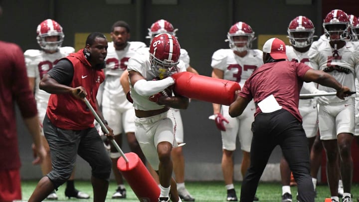 April 9, 2024; Tuscaloosa, Alabama, USA; Alabama wide receiver Kobe Prentice (6) catches a pass and fights through a drill during practice in the Hank Crisp Indoor Practice Facility at the University of Alabama.