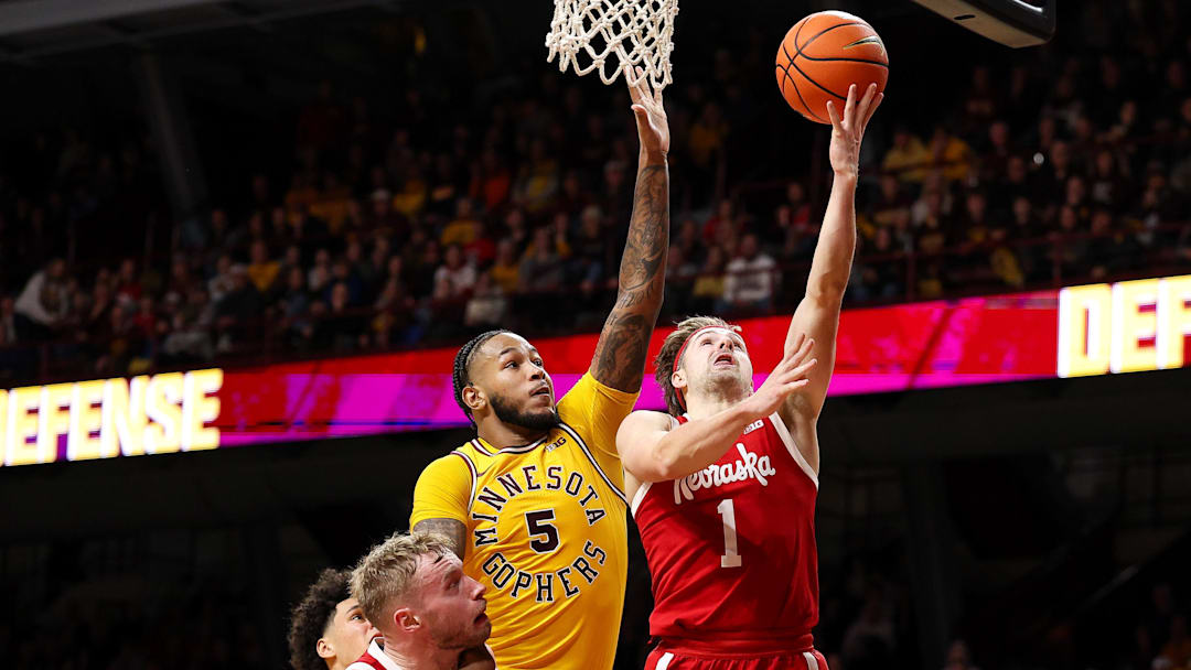 Jan 24, 2026; Minneapolis, Minnesota, USA; Nebraska Cornhuskers guard Sam Hoiberg (1) shoots as Minnesota Golden Gophers forward Jaylen Crocker-Johnson (5) defends during the second half at Williams Arena. Mandatory Credit: Matt Krohn-Imagn Images