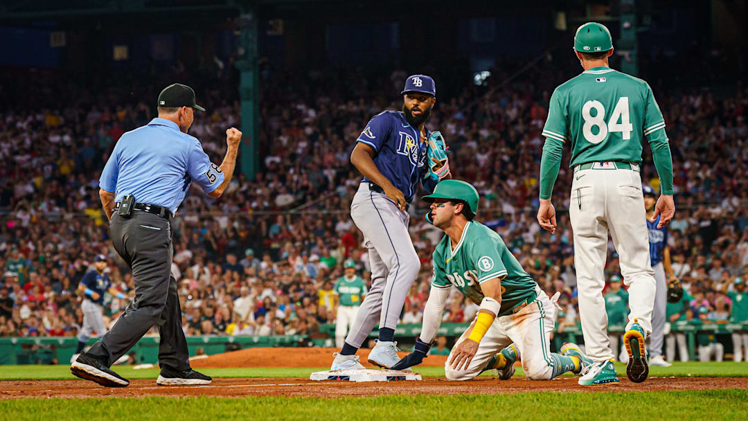Jul 11, 2025; Boston, Massachusetts, USA; Boston Red Sox first base Abraham Toro (29) out at third base by Tampa Bay Rays third base Junior Caminero (13) in the fourth inning at Fenway Park. Mandatory Credit: David Butler II-Imagn Images