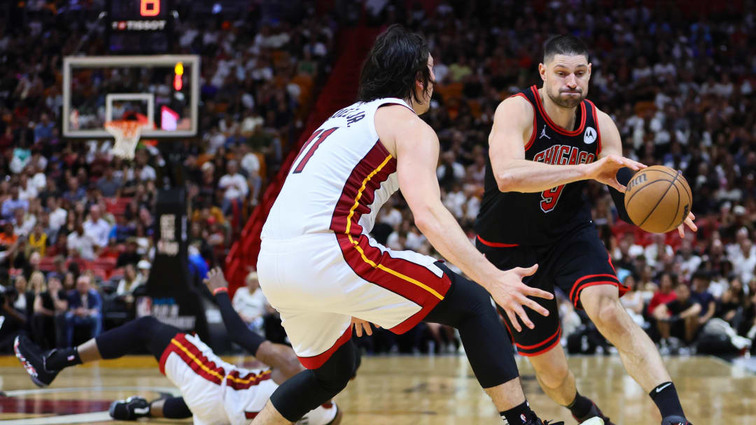 Apr 19, 2024; Miami, Florida, USA; Chicago Bulls center Nikola Vucevic (9) drives to the basket against Miami Heat guard Jaime Jaquez Jr. (11) in the second quarter during a play-in game of the 2024 NBA playoffs at Kaseya Center. Mandatory Credit: Sam Navarro-USA TODAY Sports