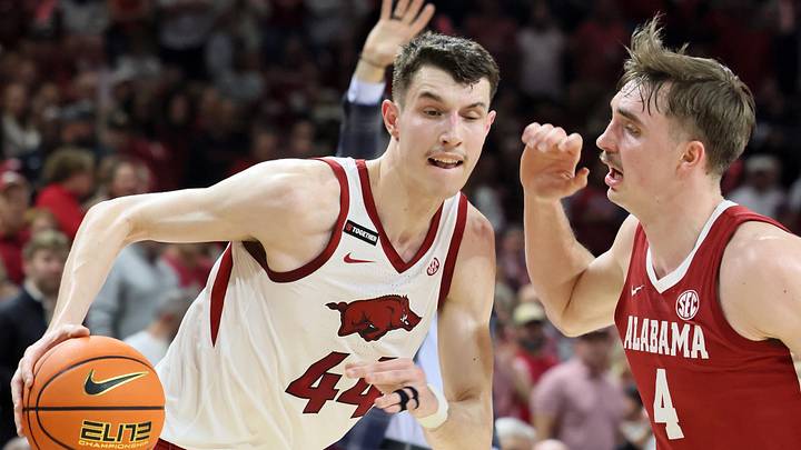 Feb 8, 2025; Fayetteville, Arkansas, USA; Arkansas Razorbacks forward Zvonimir Ivisic (44) drives against Alabama Crimson Tide forward Grant Nelson (4) during the first half at Bud Walton Arena. Mandatory Credit: Nelson Chenault-Imagn Images