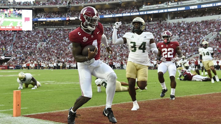 Sep 7, 2024; Tuscaloosa, Alabama, USA;  Alabama Crimson Tide quarterback Jalen Milroe (4) leaps over the goal line for a touchdown against the South Florida Bulls during the first half at Bryant-Denny Stadium. Mandatory Credit: Gary Cosby Jr.-Imagn Images