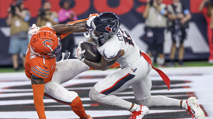 Sep 15, 2024; Houston, Texas, USA;  Houston Texans wide receiver Nico Collins (12) scores a touchdown catch against Chicago Bears cornerback Jaylon Johnson (1) in the second quarter at NRG Stadium. Mandatory Credit: Thomas Shea-Imagn Images