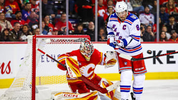 Oct 26, 2025; Calgary, Alberta, CAN; New York Rangers center J.T. Miller (8) screens in front as Calgary Flames goaltender Dustin Wolf (32) makes a save during the third period at Scotiabank Saddledome. Mandatory Credit: Sergei Belski-Imagn Images