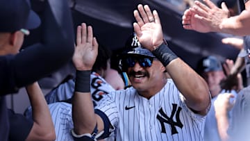 Aug 3, 2024; Bronx, New York, USA; New York Yankees center fielder Trent Grisham (12) celebrates his two run home run against the Toronto Blue Jays with teammates in the dugout during the second inning at Yankee Stadium. Mandatory Credit: Brad Penner-Imagn Images