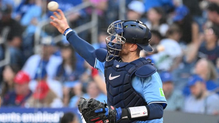 Jun 14, 2024; Toronto, Ontario, CAN;  Toronto Blue Jays catcher Danny Jansen (9) throws the ball as he prepares for the start of the second inning against the Cleveland Guardians at Rogers Centre