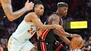 Jan 19, 2025; Miami, Florida, USA;  San Antonio Spurs guard Devin Vassell (24) defends Miami Heat forward Jimmy Butler (22) during the second half at Kaseya Center. Mandatory Credit: Jim Rassol-Imagn Images