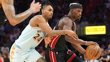 Jan 19, 2025; Miami, Florida, USA;  San Antonio Spurs guard Devin Vassell (24) defends Miami Heat forward Jimmy Butler (22) during the second half at Kaseya Center. Mandatory Credit: Jim Rassol-Imagn Images