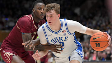 Mar 1, 2025; Durham, North Carolina, USA;  Duke Blue Devils forward Cooper Flagg (2) brings the ball around Florida State Seminoles guard Jamir Watkins (1) during the second half at Cameron Indoor Stadium.  Blue Devils won 100-65. Mandatory Credit: Zachary Taft-Imagn Images