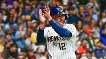 Sep 28, 2024; Milwaukee, Wisconsin, USA; Milwaukee Brewers first baseman Rhys Hoskins (12) reacts after scoring a run in the fourth inning against the New York Mets at American Family Field. Mandatory Credit: Benny Sieu-Imagn Images