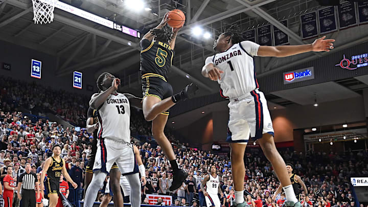 Feb 13, 2025; Spokane, Washington, USA; San Francisco Dons guard Tyrone Riley IV (5) rebounds against Gonzaga Bulldogs forward Graham Ike (13) in the second half at McCarthey Athletic Center. The Bulldogs won 88-77. Mandatory Credit: James Snook-Imagn Images