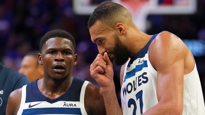 Minnesota Timberwolves guard Anthony Edwards (5) and center Rudy Gobert (27) talk during the first half of Game 3 of their first-round playoff series against the Phoenix Suns at Footprint Center in Phoenix on April 26, 2024.