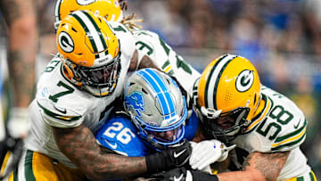 Detroit Lions running back Jahmyr Gibbs (26) runs against Green Bay Packers linebacker Quay Walker (7) and linebacker Isaiah McDuffie (58) during the second half at Ford Field in Detroit on Thursday, Dec. 5, 2024.