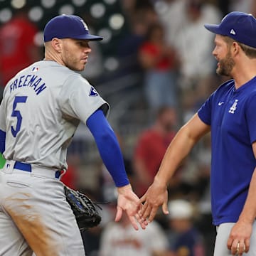 Los Angeles Dodgers first baseman Freddie Freeman (5) and starting pitcher Clayton Kershaw (22) celebrate after a victory over the Atlanta Braves.