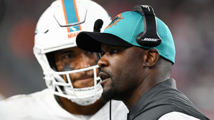 Miami Dolphins head coach Brian Flores talks with quarterback Tua Tagovailoa (1) during a timeout during the second half of the 2021 season opener against the New England Patriots at Gillette Stadium. 