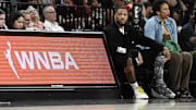 NBA player Damian Lillard sits courtside during the Las Vegas Aces and Los Angeles Sparks game at Michelob Ultra Arena. 