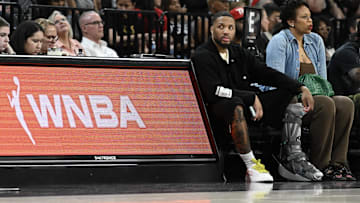 NBA player Damian Lillard sits courtside during the Las Vegas Aces and Los Angeles Sparks game at Michelob Ultra Arena. 