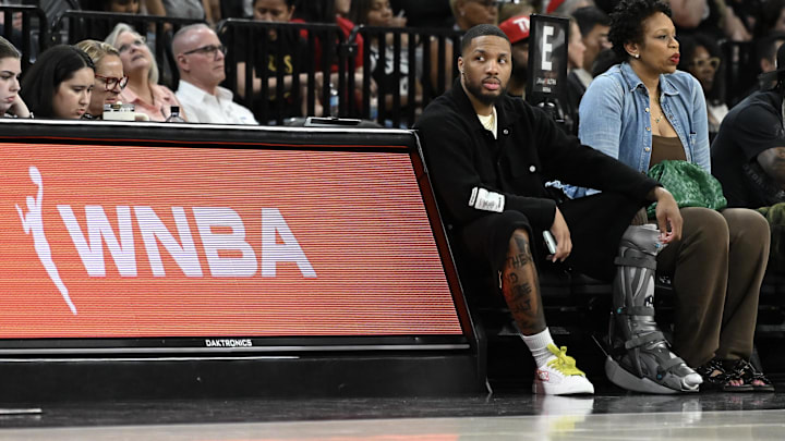 NBA player Damian Lillard sits courtside during the Las Vegas Aces and Los Angeles Sparks game at Michelob Ultra Arena. 