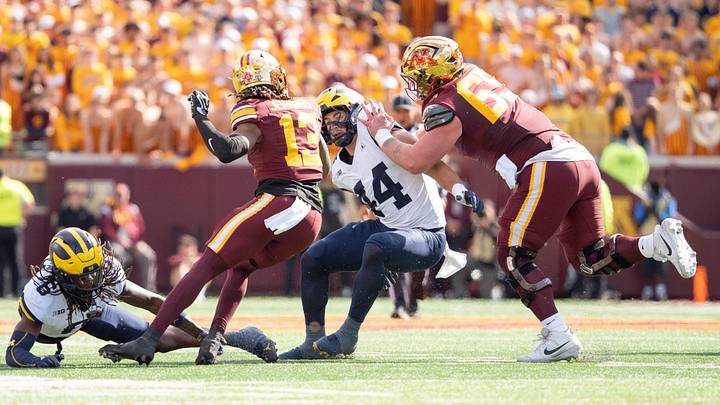 Oct 3, 2026; Minneapolis, Minnesota, USA;  Minnesota Golden Gophers wide receiver Noah Jennings (13) reverses direction taking advantage of a block from Minnesota Golden Gophers offensive lineman Greg Johnson (65) on Michigan Wolverines linebacker Nathaniel Staehling (44)in the second quarter at Huntington Bank Stadium.  Mandatory Credit: Matt Blewett-Imagn Images