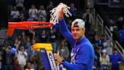 Mar 29, 2025; Newark, NJ, USA; Duke Blue Devils head coach Jon Scheyer cuts down the net after the Duke Blue Devils beat the Alabama Crimson Tide in the East Regional final of the 2025 NCAA tournament at Prudential Center. Mandatory Credit: Robert Deutsch-Imagn Images