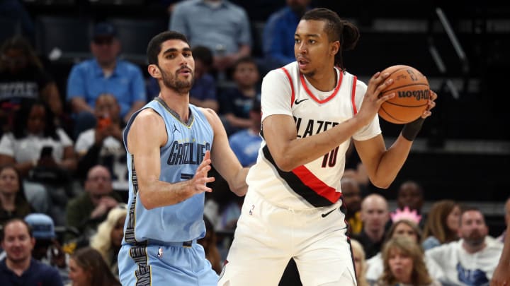 Mar 2, 2024; Memphis, Tennessee, USA; Portland Trail Blazers center Moses Brown (10) handles the ball as Memphis Grizzlies forward-center Santi Aldama (7) defends during the second half at FedExForum.