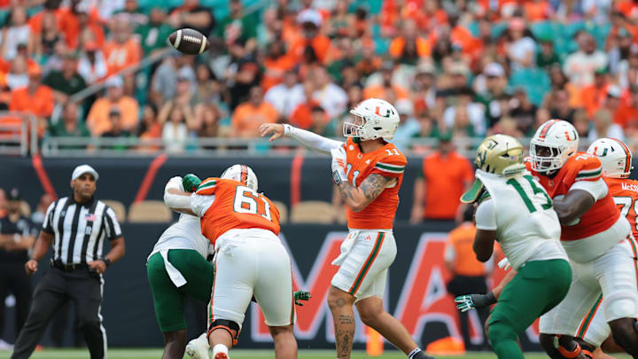 Sep 13, 2025; Miami Gardens, Florida, USA; Miami Hurricanes quarterback Carson Beck (11) passes the football against the South Florida Bulls during the first quarter at Hard Rock Stadium. Mandatory Credit: Sam Navarro-Imagn Images