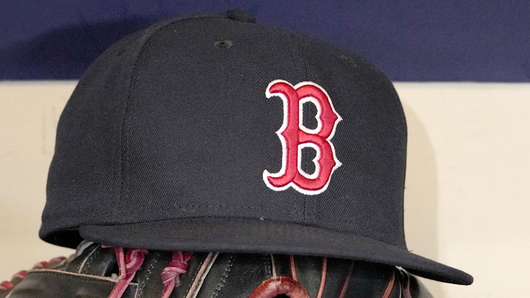 May 27, 2025; Milwaukee, Wisconsin, USA; A Boston Red Sox hat and glove sit in the dug out before a game against the Milwaukee Brewers at American Family Field. 
