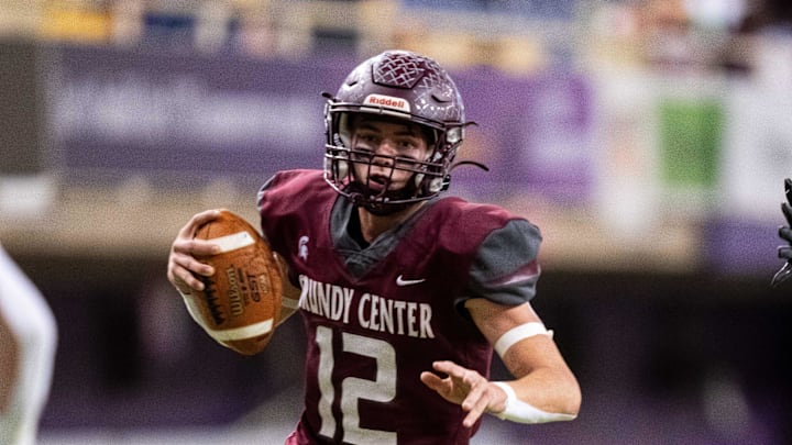 Grundy Center's Judd Jirovsky (12) keeps the ball as he runs the ball against Dike-New Hartford on Thursday, Nov. 21, 2024, at the UNI-Dome in Cedar Falls, IA.