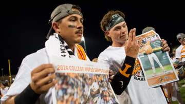 Tennessee's Hunter Ensley and Billy Amick celebrate with a special News Sentinel commemorative poster front page after game three of the NCAA College World Series finals between Tennessee and Texas A&M at Charles Schwab Field in Omaha, Neb., on Monday, June 24, 2024.