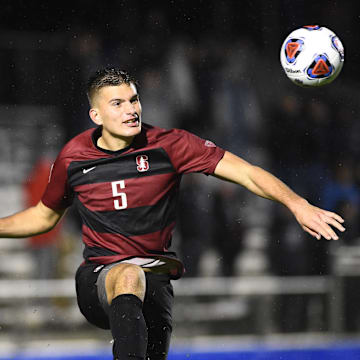 Dec 13, 2019; Cary, NC, USA; Stanford Cardinal defender Keegan Hughes (5) heads the ball in the second half at WakeMed Soccer Park. Mandatory Credit: Bob Donnan-Imagn Images