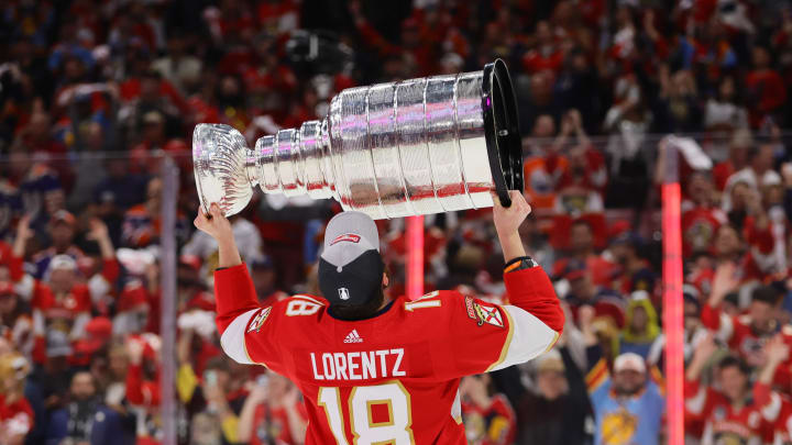 Jun 24, 2024; Sunrise, Florida, USA; Florida Panthers forward Steven Lorentz (18) hoists the Stanley Cup after defeating the Edmonton Oilers in game seven of the 2024 Stanley Cup Final at Amerant Bank Arena. Mandatory Credit: Sam Navarro-USA TODAY Sports